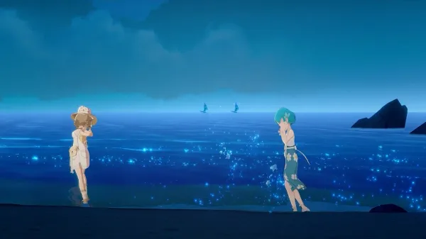 Two women running around on the beach at night with the sea behind them. The sky and sea are varying shades of blue and teal with bioluminescence under the water.