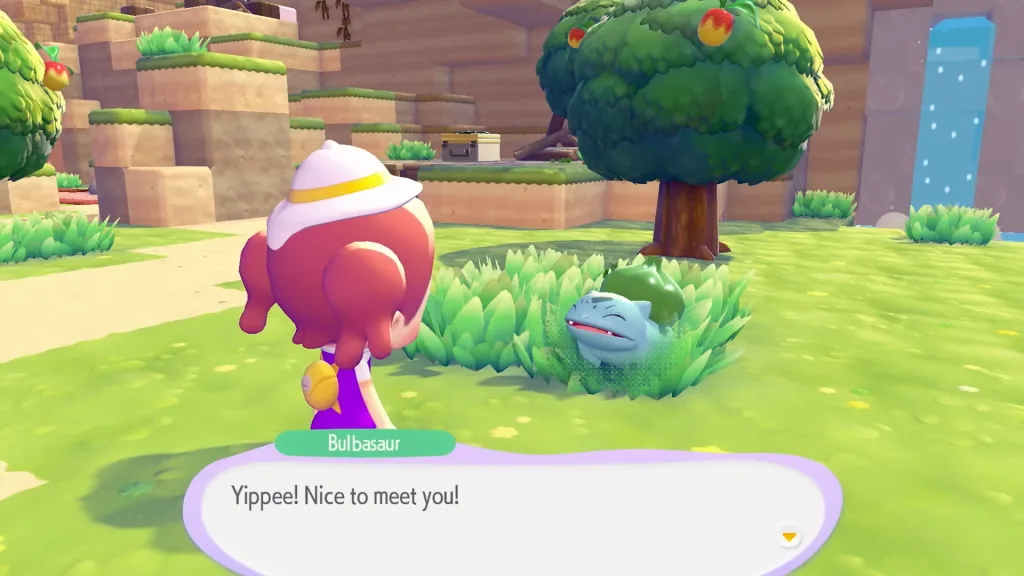 A Bulbasaur talking to a Ditto disguised as a human in Pokopia. They're saying "Yippee! Nice to meet you!". There's a tree behind them along with a water fall.