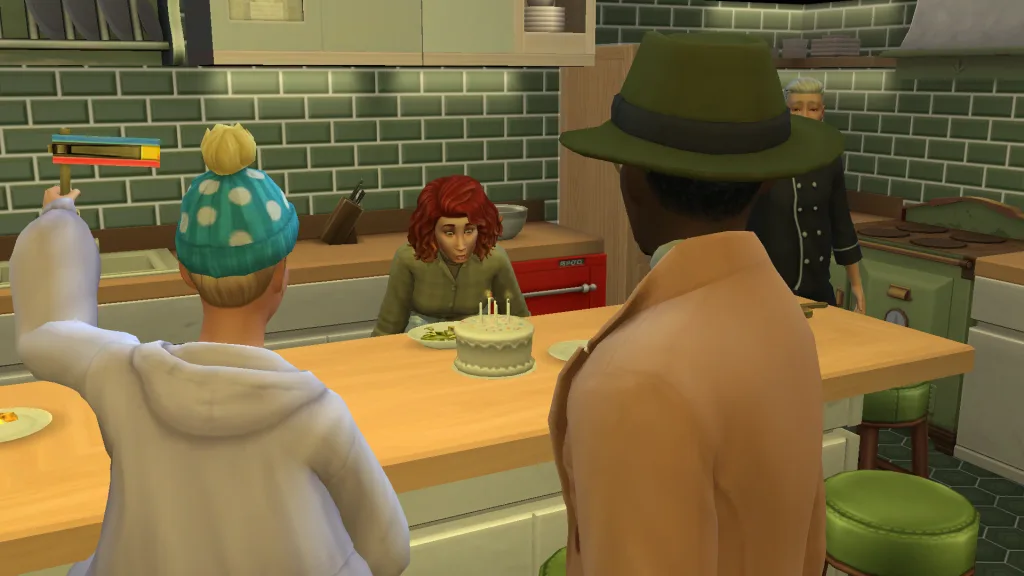 A Sim is blowing out candles on a birthday cake in The Sims 4. The room is green and two Sims stand in the foreground, including one wearing a large hat and another using a noisemaker.