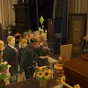 A group of Sims at a funeral in the graveyard in Ravenwood in The Sims 4: Life & Death. They're all dressed in black and orange, crying loudly.