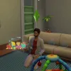 A Sim playing with toys on the ground in a neutral toned flat, showing thoughts around his head and toddler toys on the ground.