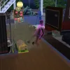 A pink ghost smashing a dollhouse in a dark toned flat in The Sims 4