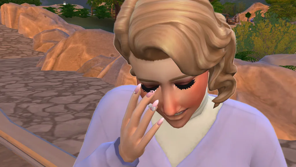 A close up of a Sim crying, holding pink nails with bows on up to her eyes. She's in Tartosa in The Sims 4: Wedding Stories.