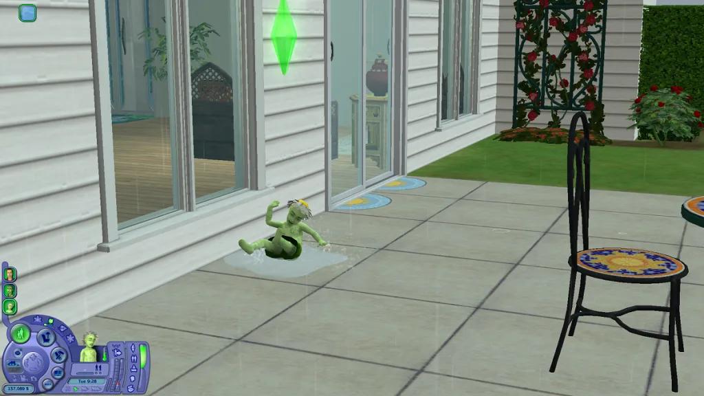 A small plantsim toddler in The Sims 2 having fun in the rain, splashing in a puddle on a patio. She's green with a leaf dress and a daisy on her head.