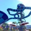 A twisted pipe slide in Waterpark Simulator which is two shades of blue, shot from below.