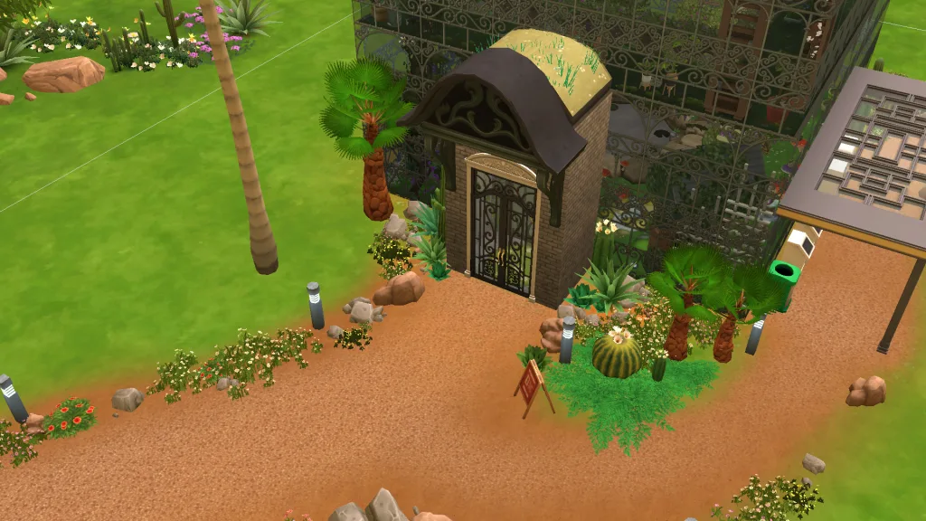 The entrance to a winter garden in The sims 4, built from glass walls with palm trees, cacti, and rocks around with, alongside plants on the roof.
