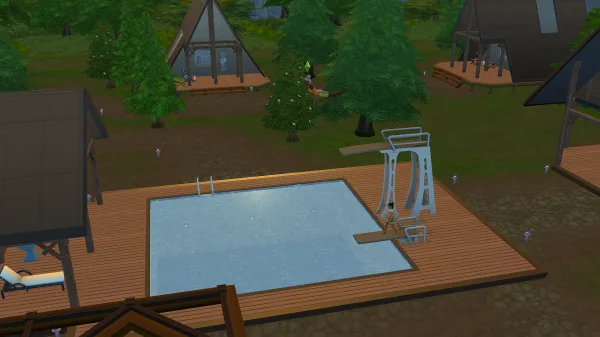 Two Sims diving in The Sims 4: Adventure Awaits in an outdoor pool with two different diving boards.