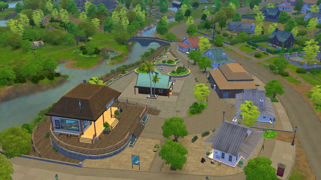 An aerial shot of some buildings, trees, and the river in Gibbi Point in The Sims 4: Adventure Awaits.