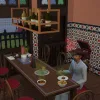 A man in a red kitchen in The Sims 4 eating food at a dinner table surrounded by dirty dishes and spoiled food.