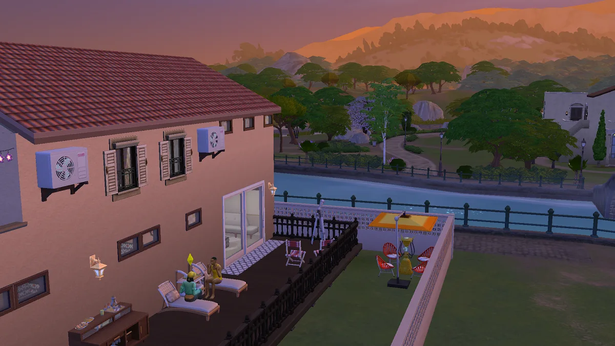 A sunset shot of a custom hotel in Tartosa in The Sims 4, showing Sims chatting on a sunlounger.