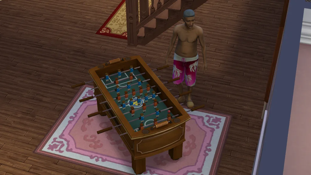 A Sim playing table football in his swimwear on a pink rug in a hotel.